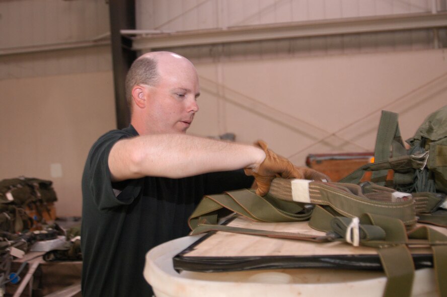 Technical Sgt. Rhett Reesing, 317th OSS air drop rigger, prepares a pallet for delivery Wednesday.                                