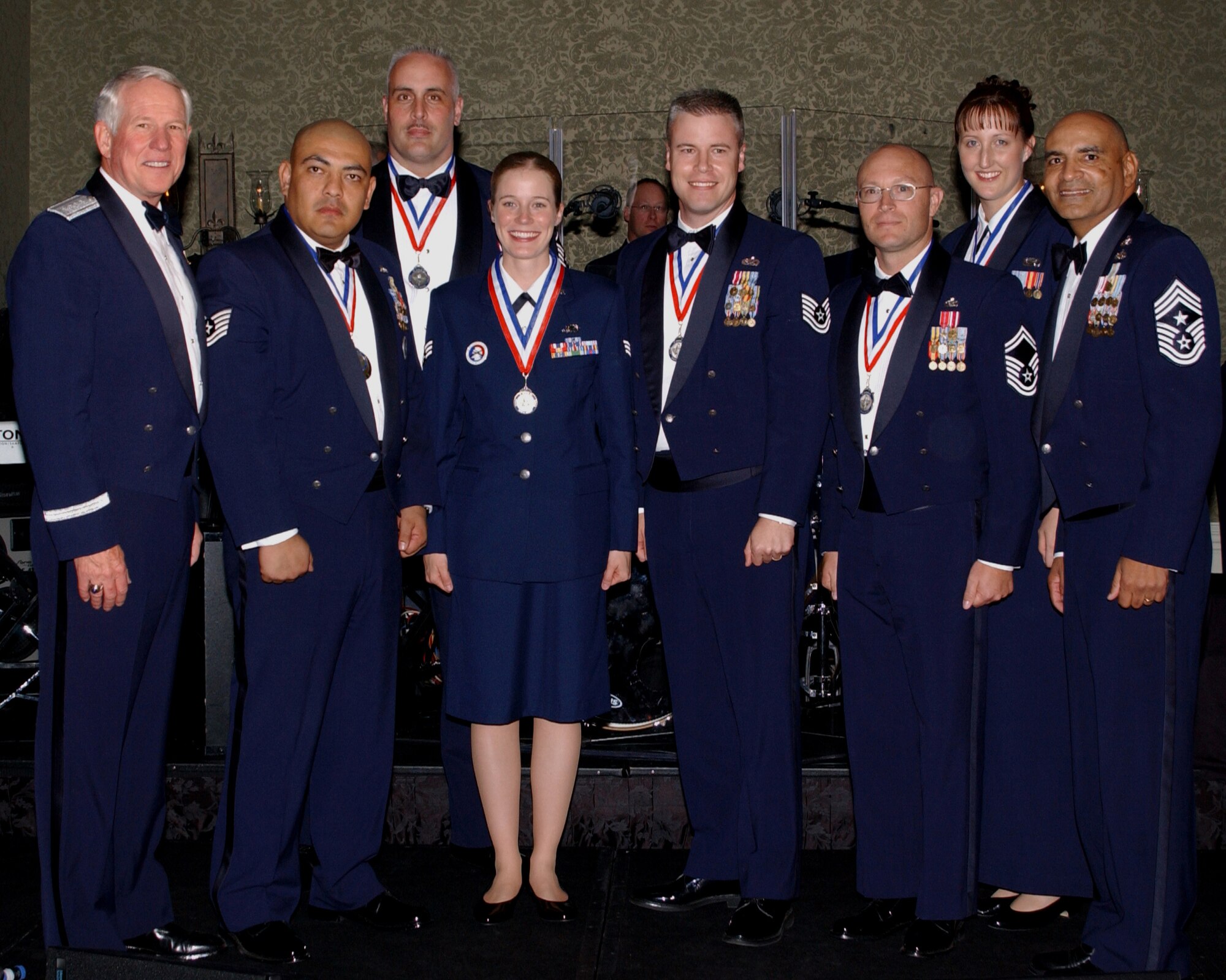 Gen. William R. Looney, Air Education and Training Command commander, and Chief Master Sgt. Rodney Ellison, AETC command chief master sergeant, stand with the 2005 AETC Outstanding Airmen of the Year.  The winners were announced during a banquet in San Antonio April 7, honoring nominees and winners.  (U.S. Air Force photo by Melissa Peterson)