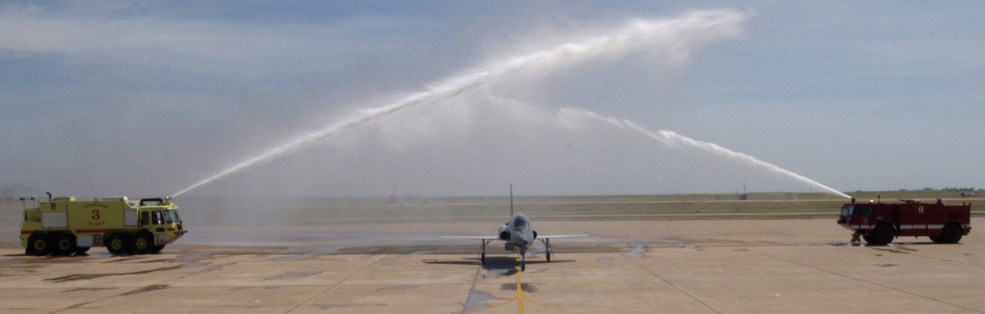 The last AT-38 Talon to fly a mission in the Air Force is given a salutatory shower after its final flight April 14 at Sheppard AFB, Texas. Col. Jeffrey Kendall, 80th Flying Training Wing commander, and Lt. Col. Richard McCool, 88th Flying Training Squadron commander, piloted the historic flight. The T-38C, with upgraded equipment, is replacing the AT-38 as the aircraft used for introduction to fighter fundamentals. (Air Force photo by Sandy Wassenmiller)