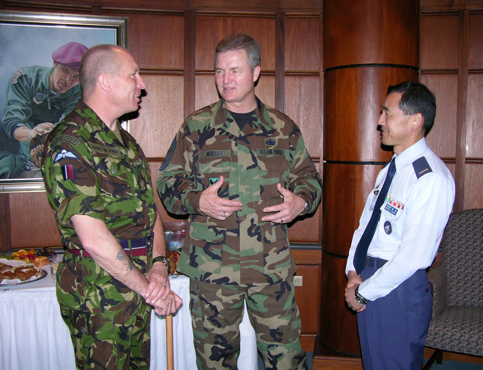 Chief Master Sgt. of the Air Force Gerald Murray discusses the progress of the World Wide Command Chiefs Conference with his British counterpart, Warrant Officer Bob Loughlin, and Japanese counterpart, Warrant Officer Ryuichi Kanomata.  The top enlisted members spoke during a break in the conference, held at the Air Force Senior NCO Academy on Maxwell-Gunter Air Force Base, Ala., April 24. (Air Force photo by Carl Bergquist)