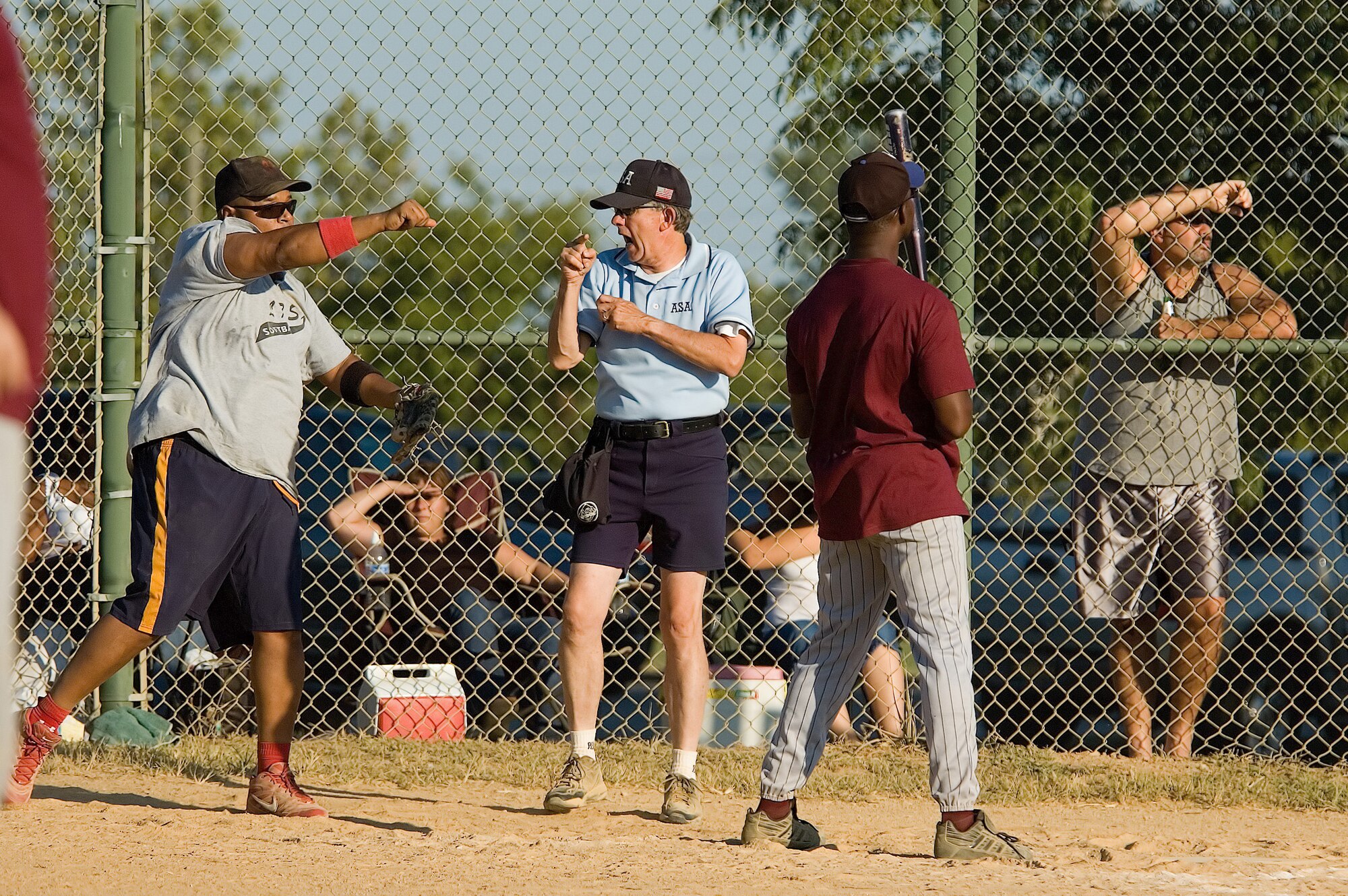 Jay Darsey (center), umpire, calls a strike on Larence Kirby (right), 436th Medical Group pinch hitter, while Michael Jackson (left), 436th Logistics Readiness Squadron catcher, throws the ball back to LRS pitcher John Bader. MDG won two games against LRS to claim Dover’s intramural softball title. (U.S. Air Force photo/Roland Balik)
