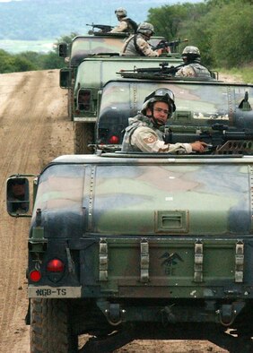 FORT HOOD, Texas -- Airmen from Iraqi Assistance Group Foxtrot training here keep a watchful eye for possible trouble May 8 along a route designed to prepare them for potential insurgent attacks when they deploy to Iraq. (U.S. Air Force photo by Master Sgt. Lee Roberts)