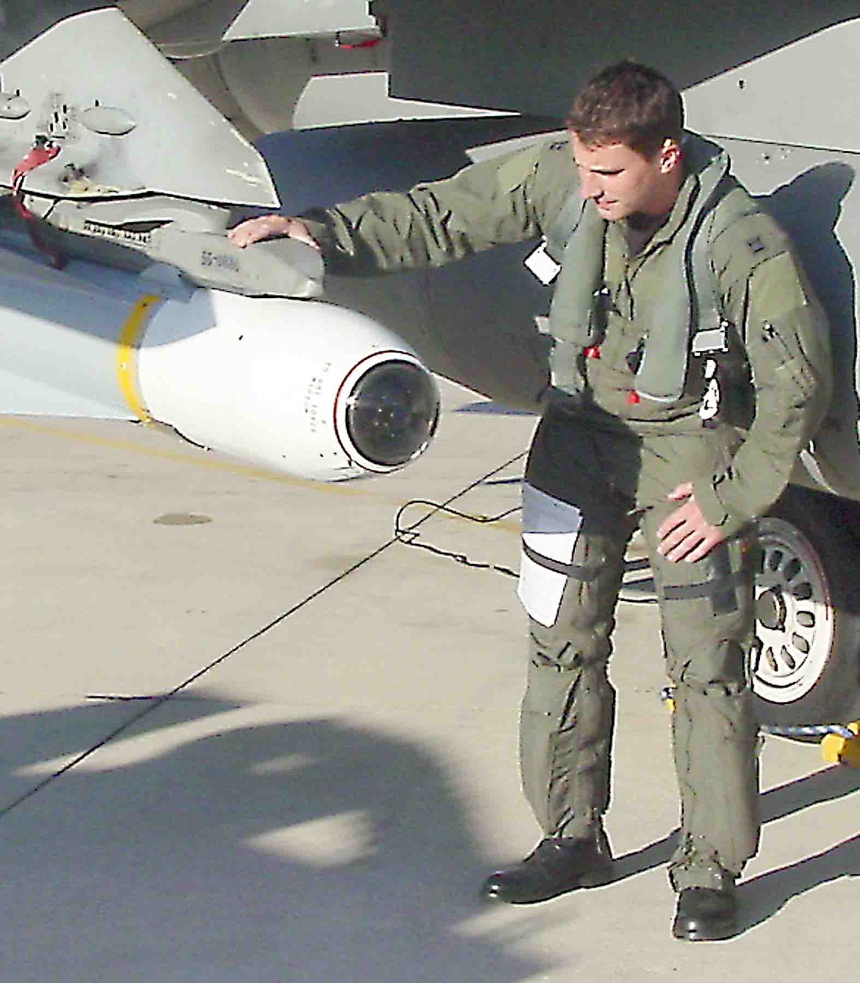 Capt. Bryan Dalton, 55th Fighter Squadron, checks a missile before his live-fire mission during the exercise Combat Hammer. (U.S. Air Force photo/Lt. Col. David Hathaway)                              