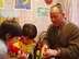 Chaplain (Capt.) Kenneth Fisher works on arts and crafts with Kristina (left) and Olga at the orphanage in Ryazan, Russia. (Courtesy Photo)