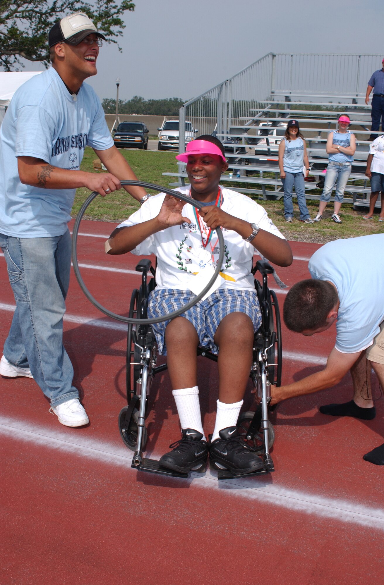 KEESLER AFB, Miss. Airman Charles Roper, (left) 335th Training Squadron student; Corey Coach, a 16-year-old athlete from Jackson, Miss.; and Airman Markus Lowe, also a 335th TRS student, display one of Coach’s tires burned off during the 30 meter non-motorized slalom at the Triangle Track. (Photo by Kemberly Groue)