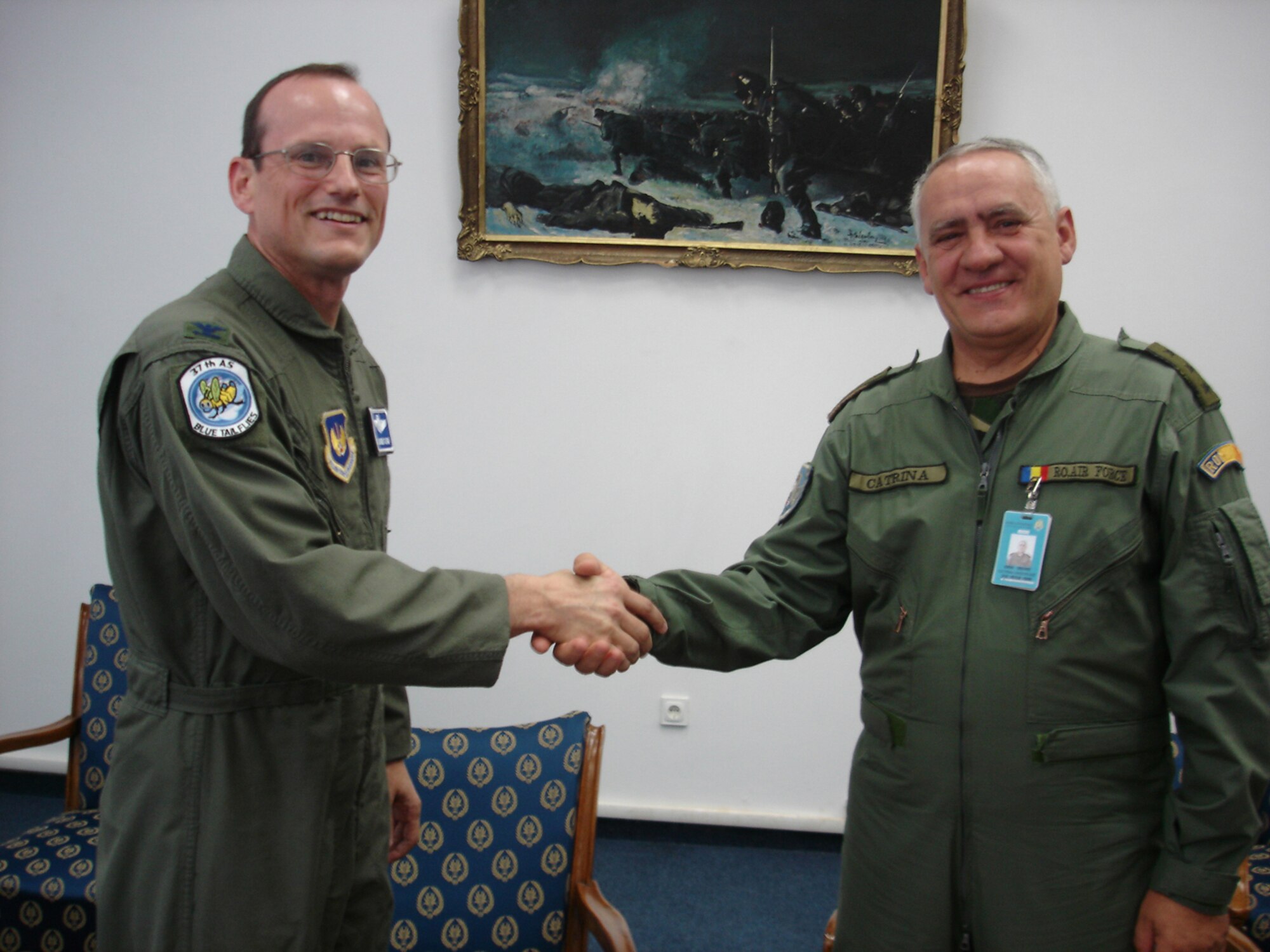 Col. Rich Johnston, KMC and 86th Airlift Wing commander, gives a wing coin to Romanian Lt. General Gheorghe Catrina, Romanian Air Force chief of staff, during a visit to Mihail Kogalniceanu Air Base Monday. Photo by Capt. Erin Dorrance.
