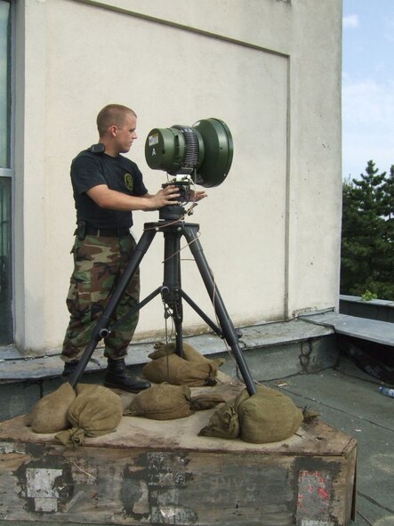 Airman 1st Class Brent Showalter, 1st Combat Communication Squadron radio maintenance technician, aims a directional wireless antenna to establish a link to a building roughly three quarters of a mile away. Airman Showalter is part of a 1st CBCS team in Mihail Kogalniceanu Air Base, Romania supporting Exercise Viper Lance 2006. Photo by Senior Airman Mariana Mijangos.