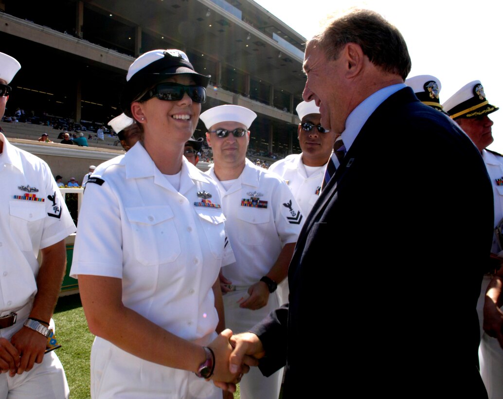 U.S. Navy Seaman Andrea Hackett, assigned to the U.S.S. Ronald Reagan, shakes hands with the son of the former president, Michael Reagan, during Navy Day at the Del Mar Thoroughbred Club in Del Mar, Calif., Aug. 23.  The racetrack opened its gates to the sailors who returned from a six-month deployment just six weeks ago.  Defense Dept. photo by Cherie A. Thurlby