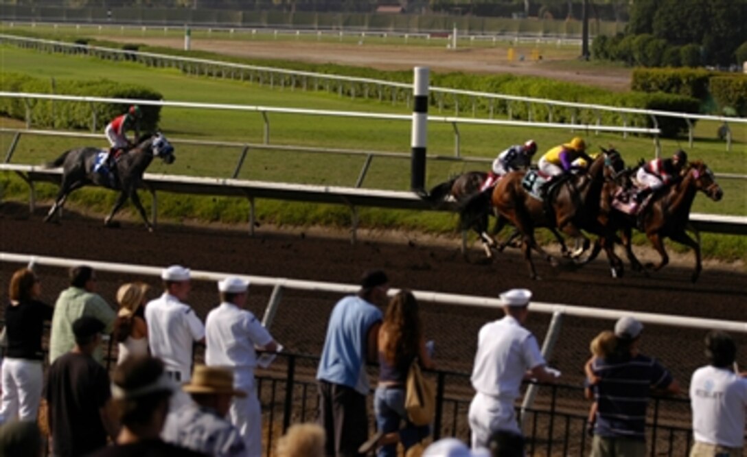 U.S. Navy sailors, assigned to the USS Ronald Reagan, watch the horses as they race around the track during Navy Day at the Del Mar Thoroughbred Club in Del Mar, Calif., Aug. 23, 2006. The racetrack opened its gates to the sailors who returned from a six-month deployment just six weeks ago. 
