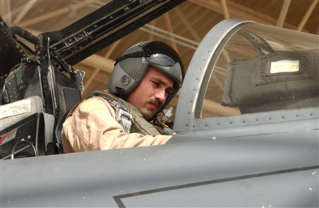 U.S. Air Force Capt. Kurt Buggeman, with the 335th Expeditionary Fighter Squadron, conducts preflight checks in an F15 Strike Eagle aircraft prior to a combat mission from an undisclosed operating location in Southwest Asia, Aug. 20, 2006.