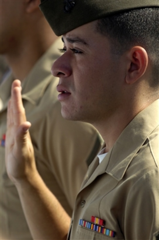 U.S. Marine Corps Cpl. Milton Trejo, from San Salvador, El Salvador, recites the oath of allegiance during a U.S. Citizenship and Immigration Services swearing-in ceremony aboard the USS Ronald Reagan (CVN 76) in Coronado, Calif., on Aug. 22, 2006.  More than 85 service members from the Navy, Marine Corps, Army and Coast Guard from 29 countries around the world participated in the naturalization ceremony aboard the aircraft carrier.  