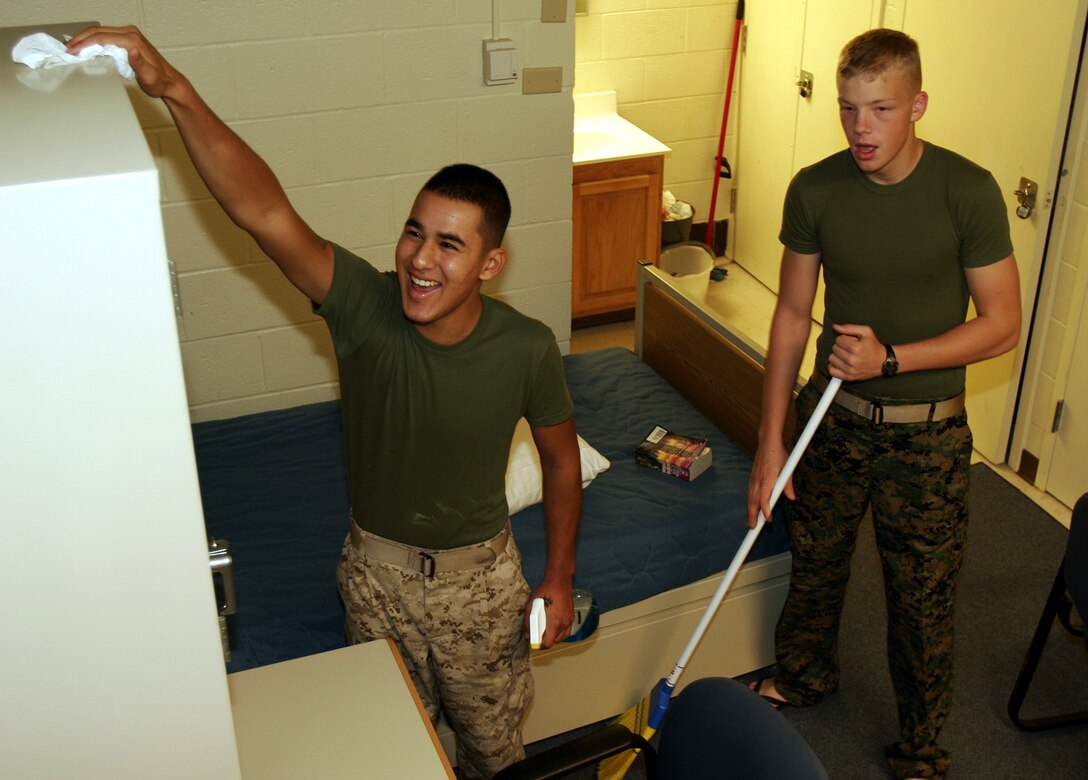 MARINE CORPS BASE CAMP LEJEUNE, N.C. ? Pfc. David V. Telles, 19, and Pfc. Jack E. Severson, 20, both systems operators assigned with Force Effects Coordination Center, II Marine Expeditionary Force, do a general cleanup of their barracks room for Friday?s inspection. Field day helps maintain the health and comfort of Marines and sailors who reside in enlisted quarters.