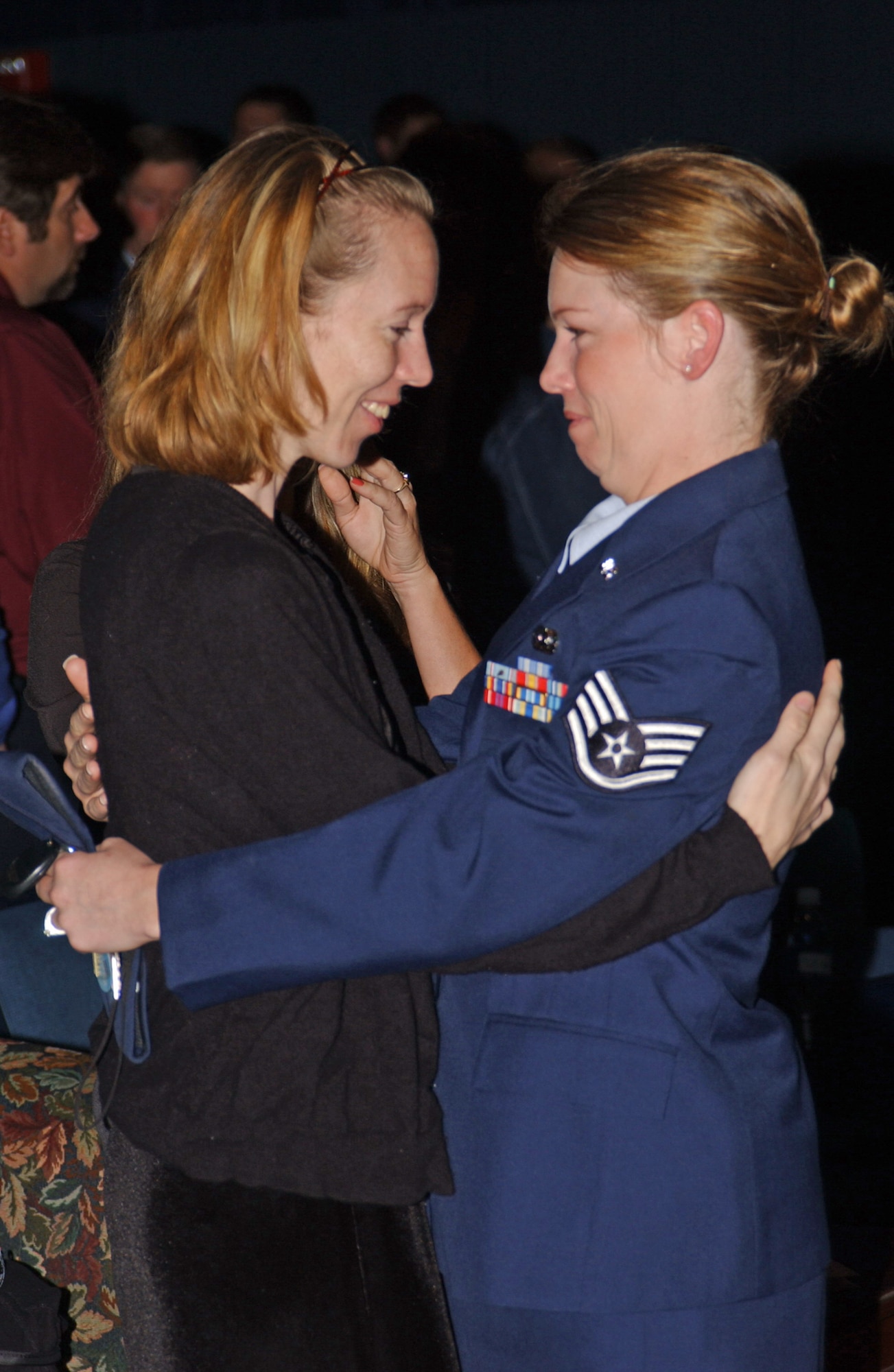 EIELSON AIR FORCE BASE, Alaska--Staff Sgt. Robyn Finch, 354th Maintenance Squadron NCO in charge of information management, consoles Rebecca Clemmons,
wife of Master Sgt. Brad Clemmons, 354th Civil Engineer Squadron explosive ordnance disposal craftsman, at his memorial service here Thursday.  Sergeant Clemmons lost his life Aug. 21 in support of Operation Iraqi Freedom while traveling in a convoy en route to Taji, Iraq, when his vehicle was struck by an improvised explosive device.  (U.S. Air Force photo by Airman Christopher Griffin)