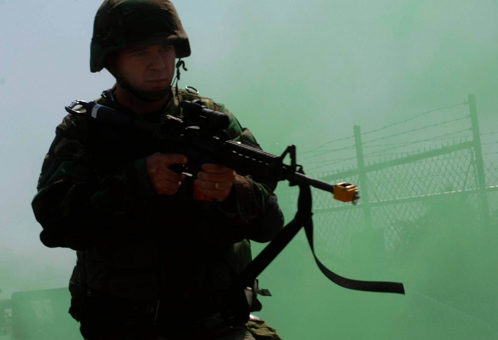 A tactical response team member enter a Minuteman III launch training facility during a coordinated security training exercise, Aug. 22. The team will move across the area after a simulated grenade attack that should clear the area of living enemy attackers. They remain ready for any possible tricks, traps or explosive devices that the opposition force may have left for them. All personnel are with the 91st Security Forces Group, Minot Air Force Base, N.D. (U.S. Air Force photo/Master Sgt. Lance Cheung)
