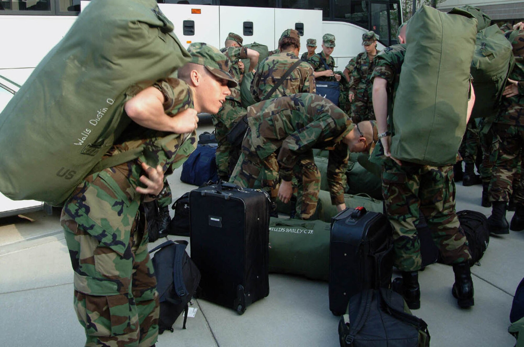 Airman Basic Dustin Walls from Milton, Pa., retrieves his bag after arriving at Keesler AFB Oct. 31 following a bus trip from Lackland Air Force Base, Texas. He's assigned to the 332nd Training Squadron. (U.S. Air Force photo by Herb Welch)