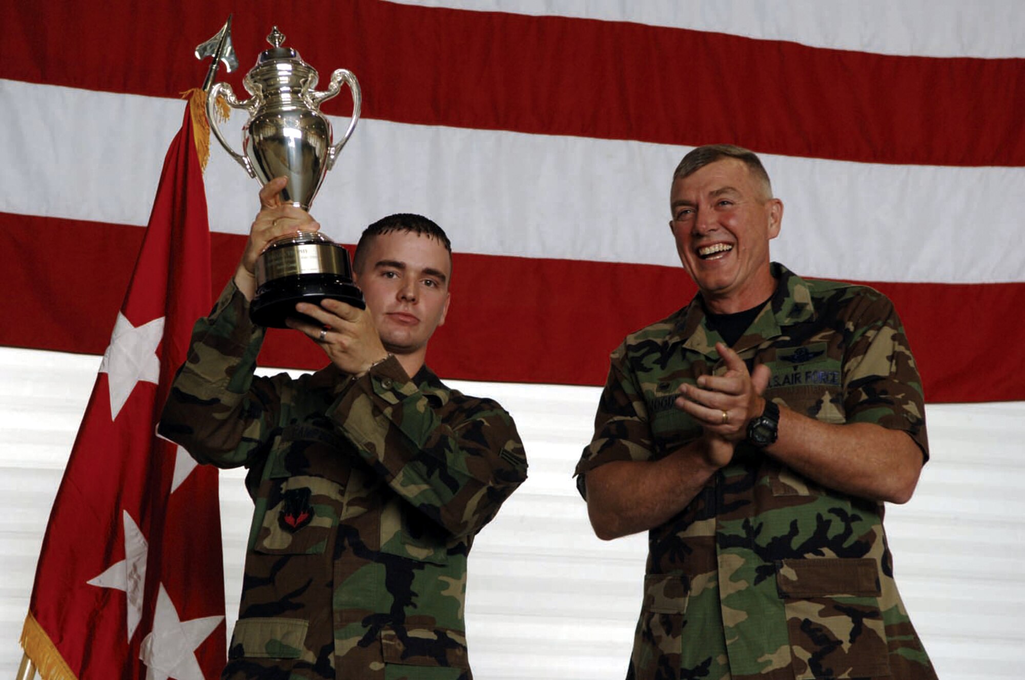 MINOT AIR FORCE BASE, N.D. -- Senior Airman Neil Campbell, 5th Security Forces Squadron, holds up the Omaha trophy with Col. Eldon Woodie, 5th Bomb Wing commander. The 5th Bomb Wing won the trophy for its strategic aircraft operations in 2005. (U.S. Air Force photo by Airman 1st Class Christopher Boitz)