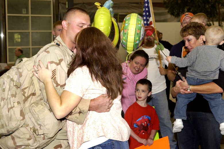 Staff Sgt. Benjamin Harting, 460th Security Forces Squadron, is welcomed home by his wife at Denver International Airport Aug. 19.  Twelve other security forces members also returned home from their six-month deployment to Iraq.  (U.S. Air Force photo by Senior Airman Steven Czyz)                               