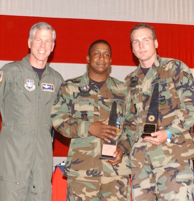 Maj. Gen. William Shelton, 14th Air Force commander, presents the Space Communications team award to Staff Sgt. Tavius English and Senior Airman Daniel McCoy, 460th Space Communications Squadron members, at the Guardian Challenge 2006 awards presentation. (U.S. Air Force photo by Senior Airman Taylor Marr)                              