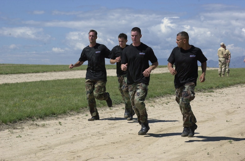Tech. Sgt. Travis Silvers, from the 137th Space Warning Squadron, Senior Airman Christopher Malloy and Senior Airman Matthew Masciorini, from the 460th Security Forces Squadron, and Senior Airman Romy Vazquez, from the 137th SWS, run as the 460th SFS team in the Guardian Challenge 2006. (U.S. Air Force photo by Airman 1st Class Michelle Cross )                              