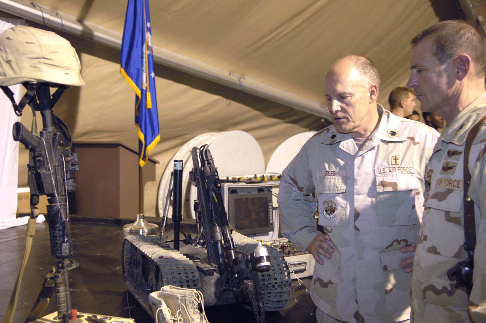 Observing a quiet moment after the memorial service for Master Sgt. Brad A. Clemmons, Chaplain (Lt. Col.) Stan Giles and Col. Duane D. Lamb pay their respects at a memorial made of explosive ordnance tools Aug. 24 at Balad Air Base, Iraq. Sergeant Clemmons died Aug. 21 when his vehicle struck an improvised explosive device near Taji, Iraq. Chaplain Giles is the 732nd Expeditionary Mission Support Group chaplain and Colonel Lamb is the group commander. (U.S. Air Force photo/Senior Airman Andrew Oquendo)