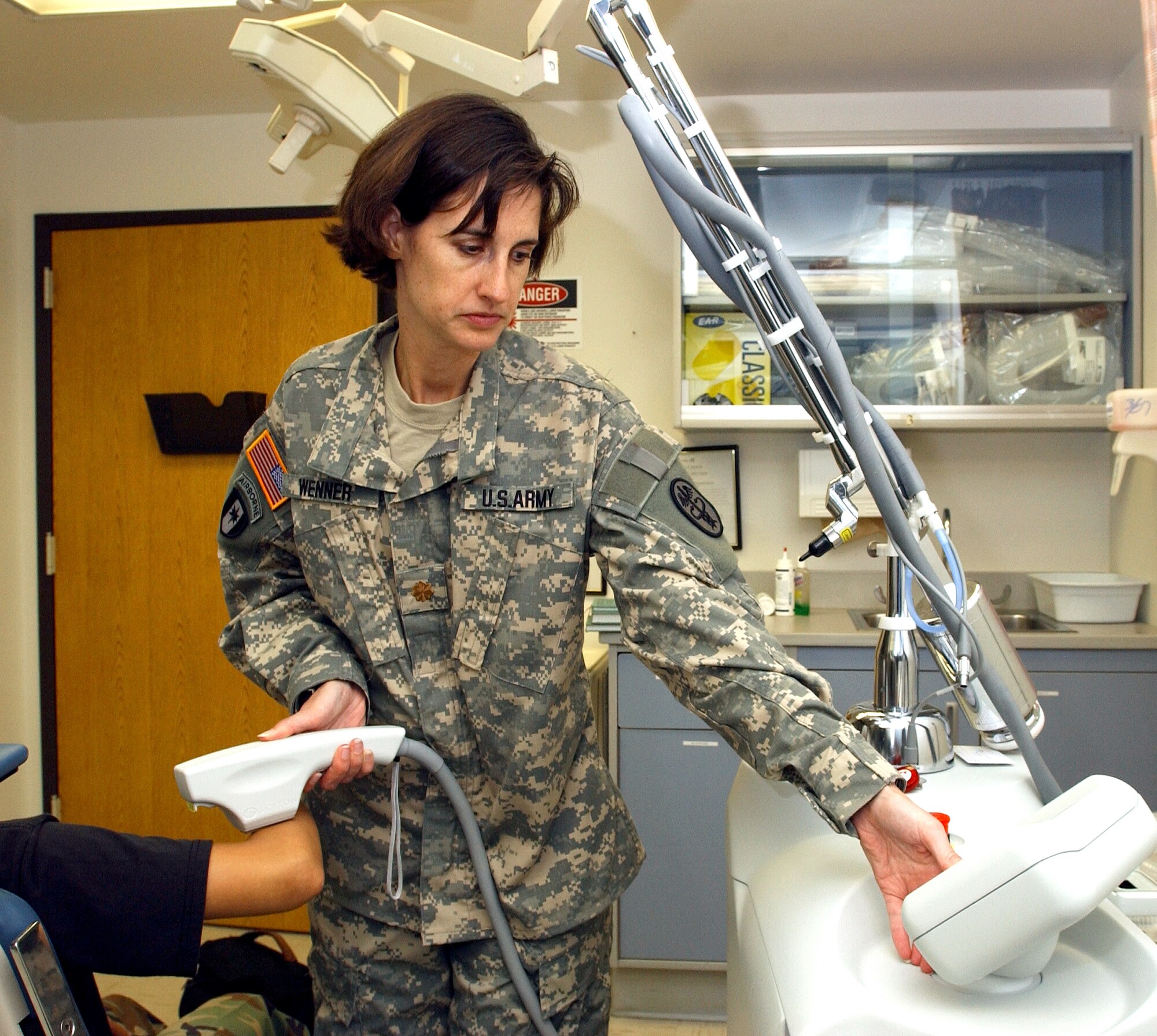 Army Maj. Kimberly Wenner uses a Sciton Laser to remove severe scarring while working in the 59th Medical Wing's dermatology clinic at Lackland Air Force Base, Texas, Aug. 27. Major Wenner is a second-year dermatology resident assigned to the 59th Medical Wing. (U.S. Air Force photo/Master Sgt. Kimberly Yearyean-Siers)