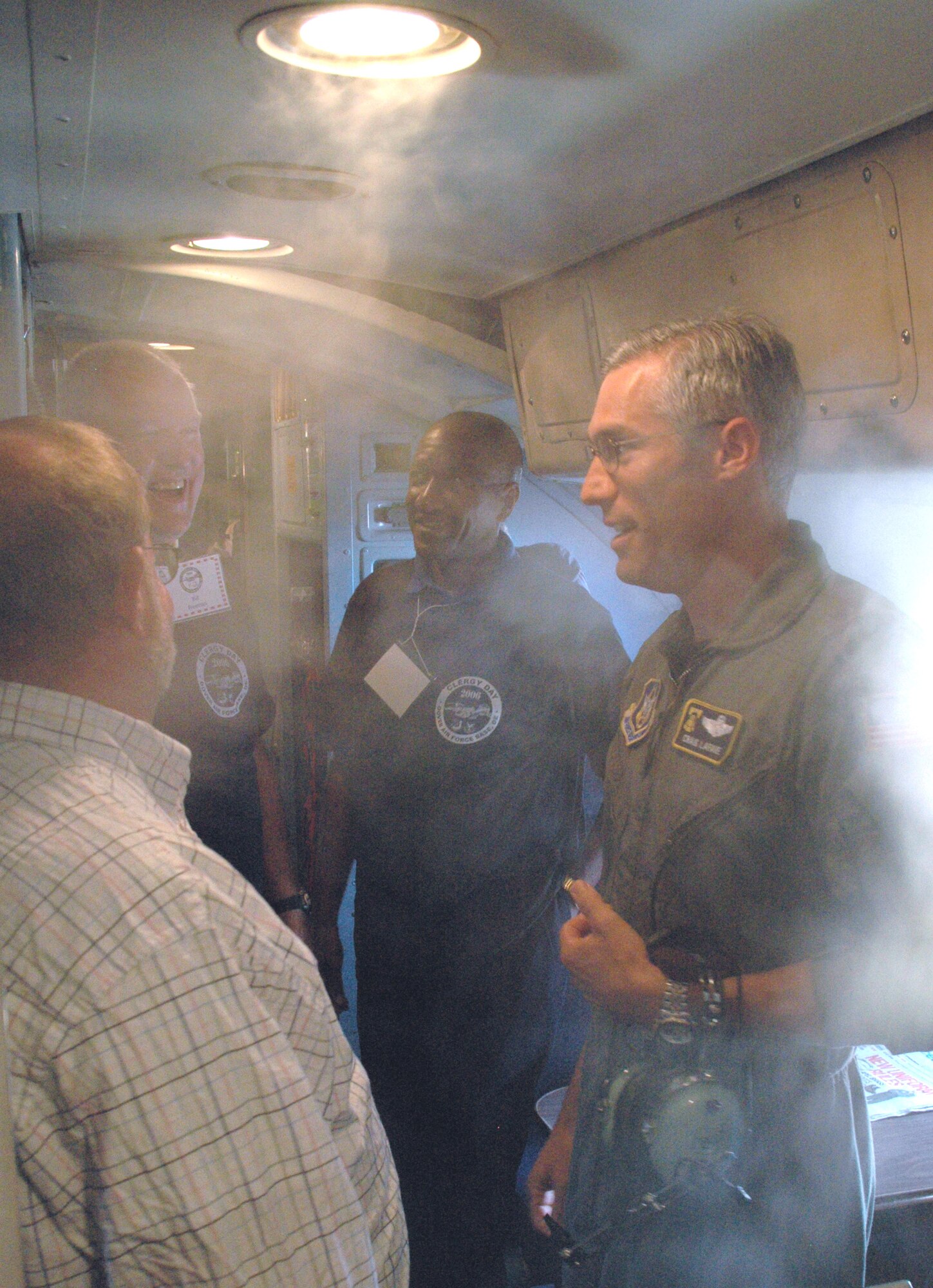 Lt. Col. Craig LaFave, 512th Airlift Wing C-5 pilot, gives a preflight safety brief amid a condensation haze in the crew compartment of a C-5 during Clergy Day Aug. 14 at Dover Air Force Base, Del.