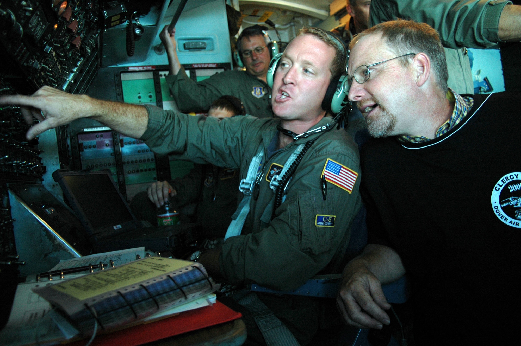 Tech. Sgt. Glenn Bailey, 709th Airlift Squadron, explains the engineer's panel to Keystone-state Pastor Tony Stephens.   The pastor was one of 38 clergy members who attended the Dover Air Force Base Clergy Day Aug. 14.