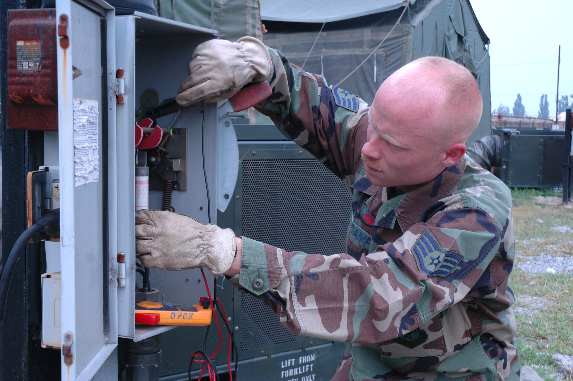 Staff Sgt. Eric Camp checks voltage and amperage usage on one of the tent city tents at Osan Air Base, South Korea, Aug. 24. Sergeant Camp is an electrical systems craftsman with the 51st Expeditionary Support Squadron deployed from Kadena AB, Japan, for Exercise Ulchi Focus Lens. (U.S. Air Force photo/Senior Airman Brok McCarthy)
