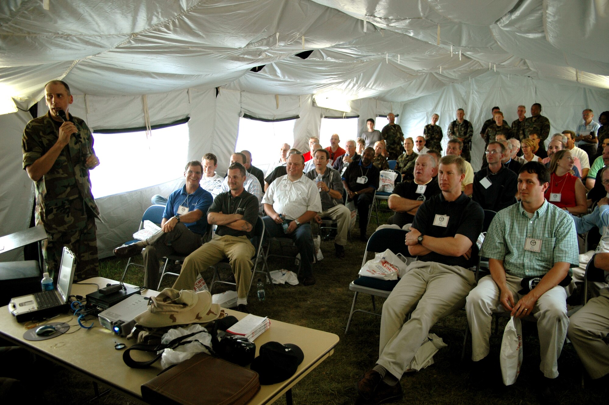 Chaplain (Lt. Col.) John Groth, 512th Airlift Wing, gives clergy the lowdown on downrange devotion in a mock field chapel near Chapel 2 on Clergy Day, Aug. 14. at Dover Air Force Base, Del. The 512th AW is an Air Force Reserve Command unit.