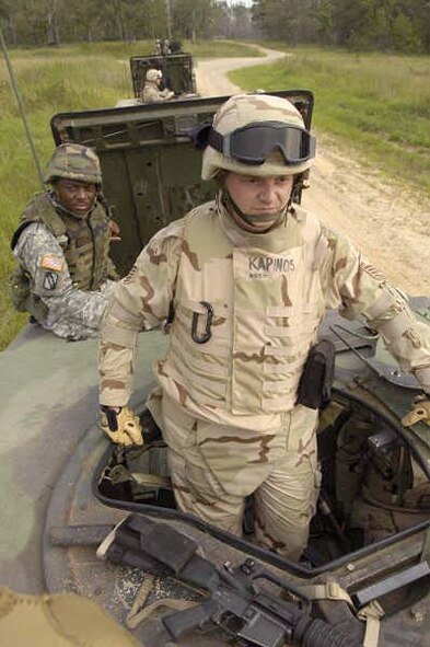 Tech. Sgt Joseph Kapinos surveys the live fire range with training adviser Staff Sgt. Kevin Matthews before a mounted combat patrol exercise at Camp Shelby, Miss., Aug. 21. Sergeant Kapinos is from Grand Forks Air Force Base, N.D., and among 100 Airmen participating in the 39-day combat skills training course. (U.S. Air Force photo/Master Sgt Scott Wagers)