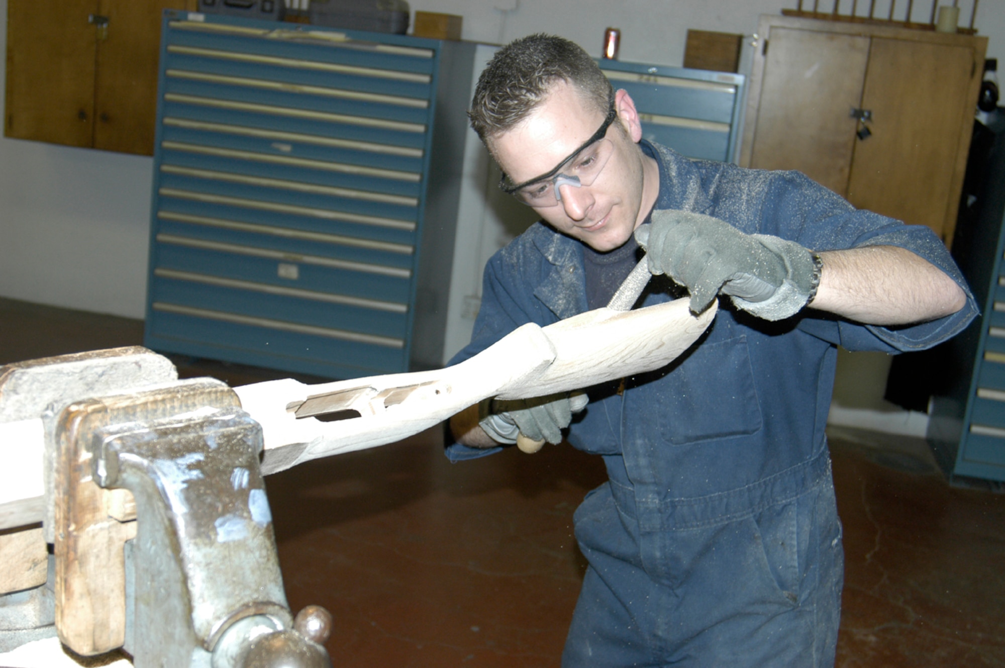 Staff Sgt. Brendan McGloin, a combat arms member of the U.S. Air Force Gunsmith Integrated Product Team, sands a wooden stock for a Remington .308-caliber rifle Jan. 20 in the team’s shop on Lackland Training Annex. (U.S. Air Force photo by James Coburn)