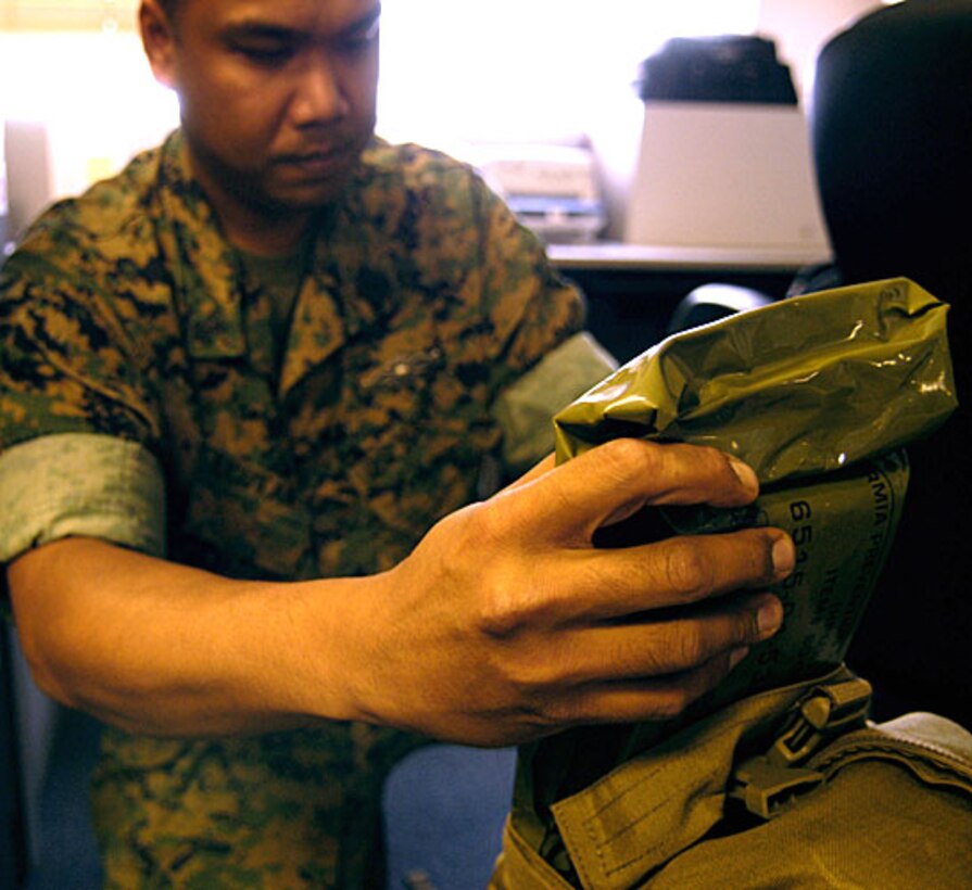 U.S. Navy Petty Officer 1st Class John Jucutan, 15th Marine Expeditionary Unit, packs a specialized medical bag in preparation for an upcoming deployment, at Camp Pendleton, Calif., Aug. 23, 2006.  This will be Jucutan’s eighth deployment with the Marines during his 18-year career.  