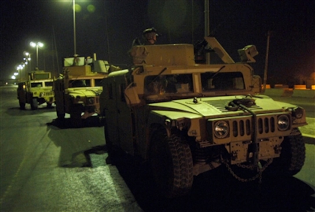 U.S. Army soldiers with the 4th Battalion, 320th Field Artillery, 506th Regimental Combat Team, 101st Airborne Division conduct a night patrol in the Zafaraniya District of East Baghdad, Iraq, on Aug. 13, 2006.  