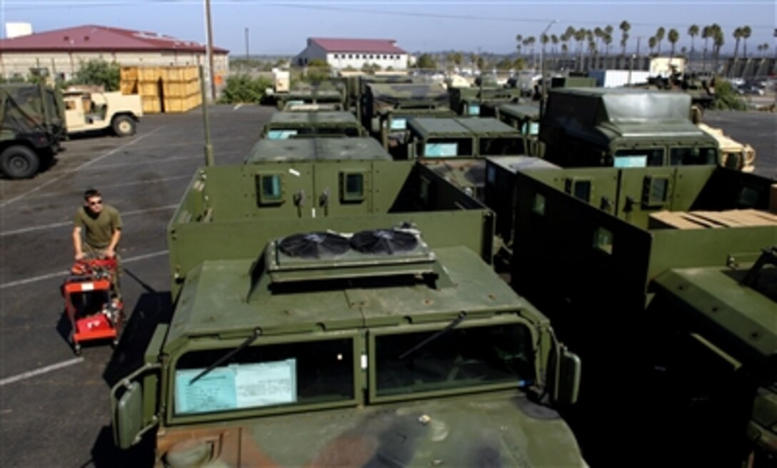 U.S. Marine Corps Sgt. Bobby Savicke, motor transportation mechanic, pushes a tool cart out to one of the vehicles in order to inspect it, in preparation for an upcoming deployment, at Camp Pendleton, Calif., Aug. 23, 2006.  This will be Savicke’s second “float” with the 15th Marine Expeditionary Unit.  