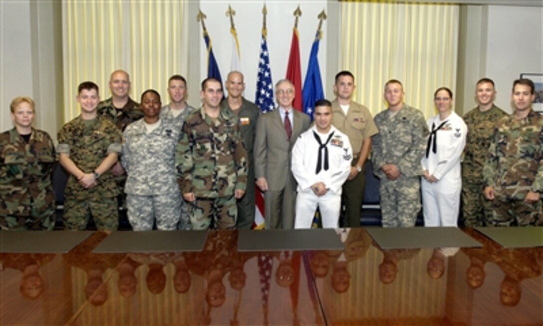 Thirteen servicemembers who served in Iraq or Afghanistan meet with Deputy Defense Secretary Gordon England before they begin their speaking tour across the country as part of the 'Why We Serve' program.