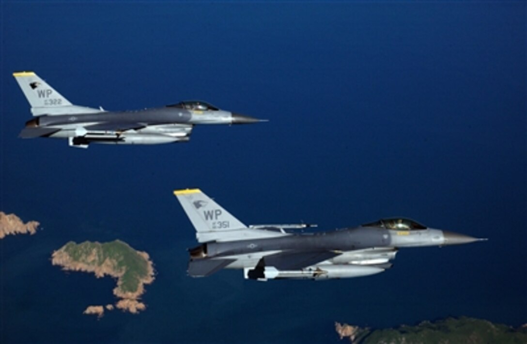 Two F-16 Fighting Falcon aircraft from the 80th Fighter Squadron fly to the range on Kunsan Air Base, Korea, on Aug. 15, 2006, to practice for an AIM-9 Sidewinder air-to-air missile live-fire exercise.  