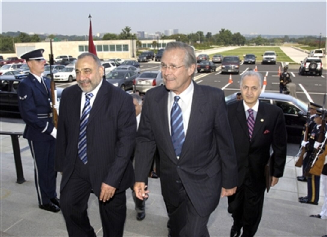 Secretary of Defense Donald H. Rumsfeld (right) escorts Iraqi Deputy President Adil Abd Al-Mahdi (left) through an honor cordon and into the Pentagon on Aug. 25, 2006.  Rumsfeld and his senior advisors will hold talks with Al-Mahdi over lunch.  