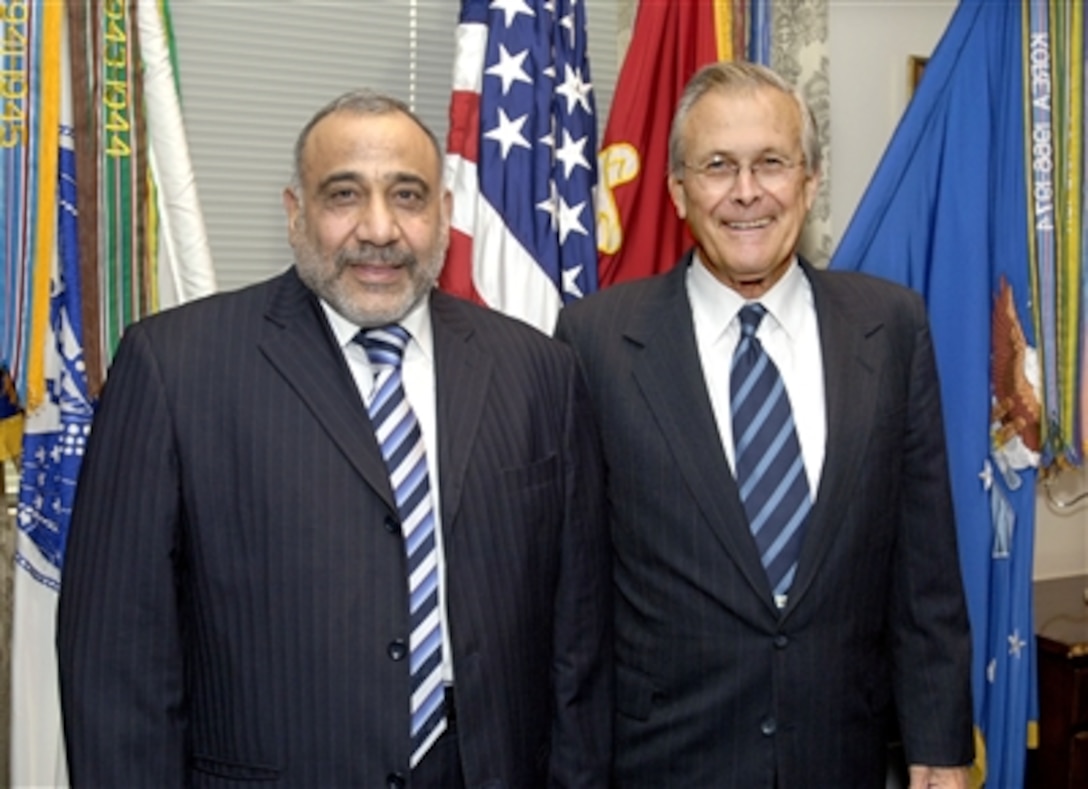 Iraqi Deputy President Adil Abd Al-Mahdi (left) and Secretary of Defense Donald H. Rumsfeld (right) pose for photographers at the Pentagon before sitting down to a luncheon meeting on Aug. 25, 2006.  