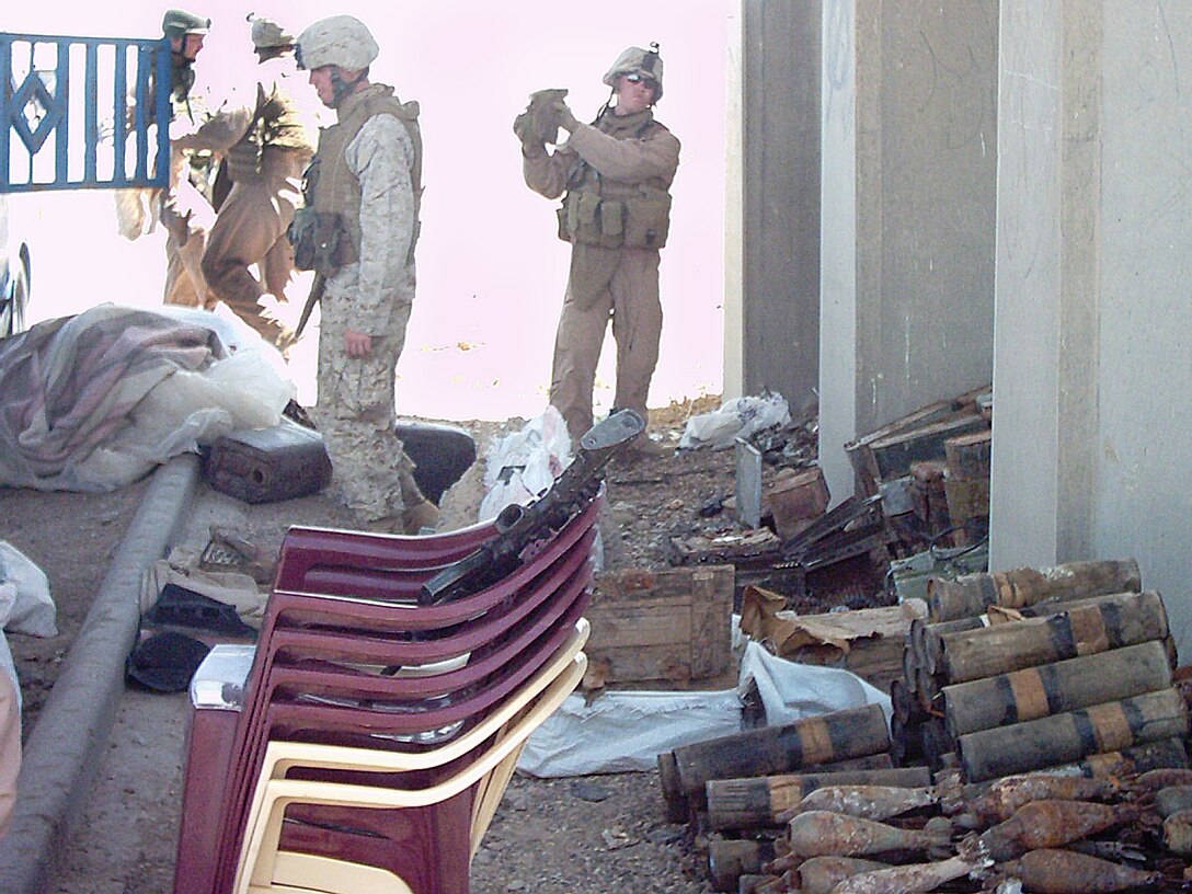 Marine scouts from TOW Platoon, 2nd Tank Battalion, attached to Team Gator from D Company, 2nd Assault Amphibian Battalion, unload massive amount of weapons and munitions snatched from insurgents during a snap vehicle checkpoint.  Marines rolled up hundreds of weapons commonly used in insurgent attacks.
