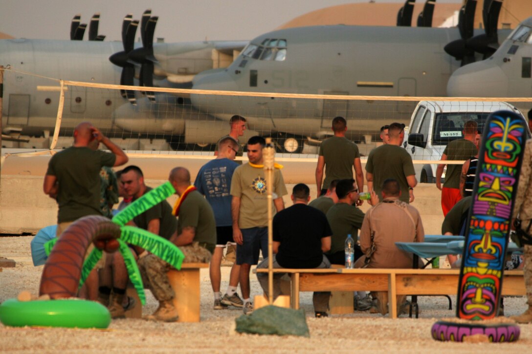 Several Marines and civilians enjoy themselves during the Iraqi luau next to the KC-130J Hercules hangars at Al Asad, Iraq, Aug. 27. The festivities were brought on to celebrate the end of the deployment for Marine Aerial Refueler Transport Squadron 352, Marine Aircraft Group 16 (Reinforced), 3rd Marine Aircraft Wing (Forward). The squadron also used the gathering to welcome their replacements to Iraq and thank the different units who have helped them in the past six months.