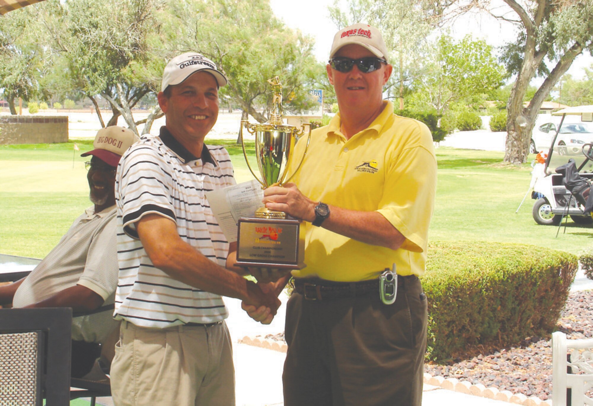 Ralph Aegan accepts his trophy from Col. Gary Bryson, 49th Maintenance Group Commander.