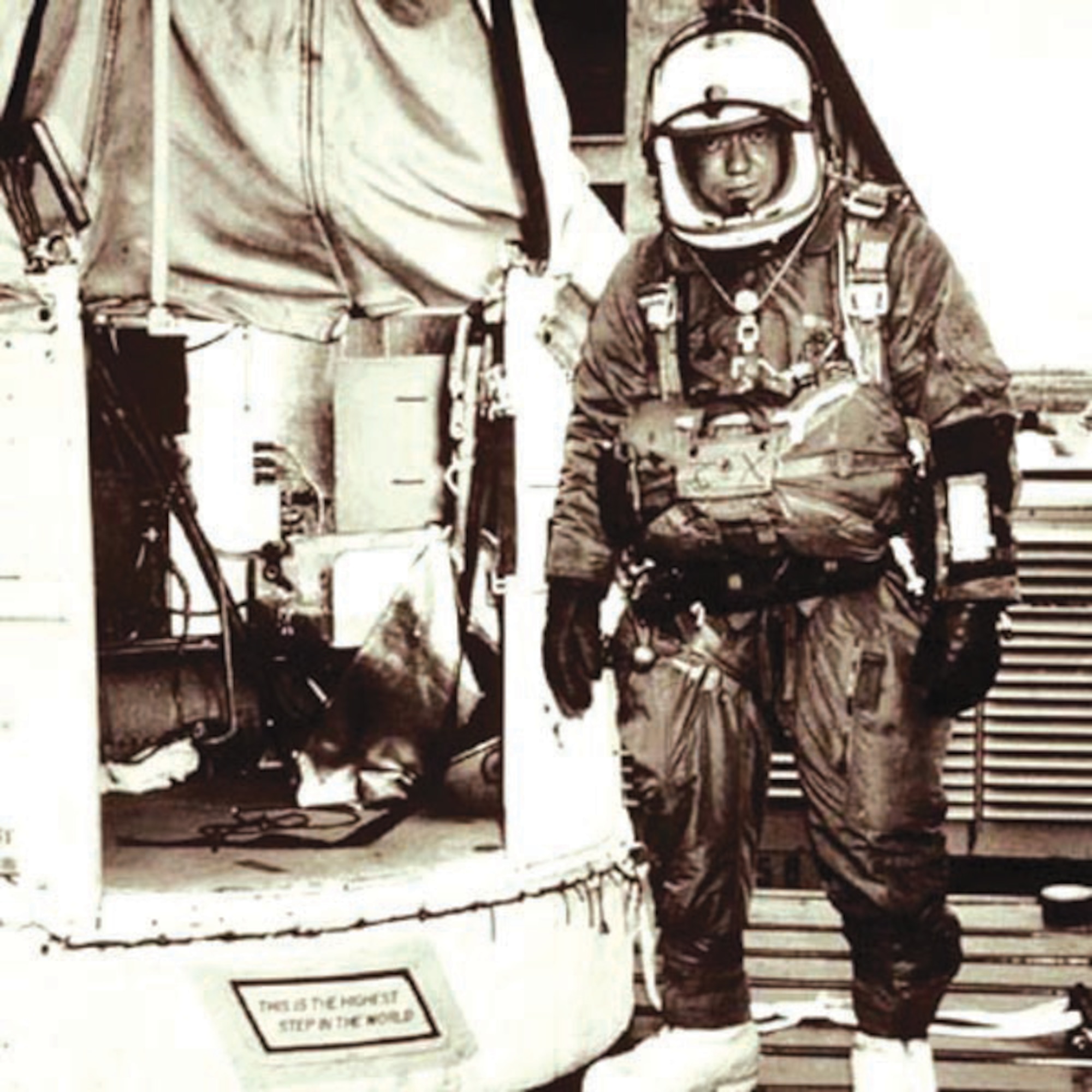 Capt. Joseph Kittinger stands outside the balloon gondola Excelsior III. The sign on the gondola step reads "This is the highest step in the world."