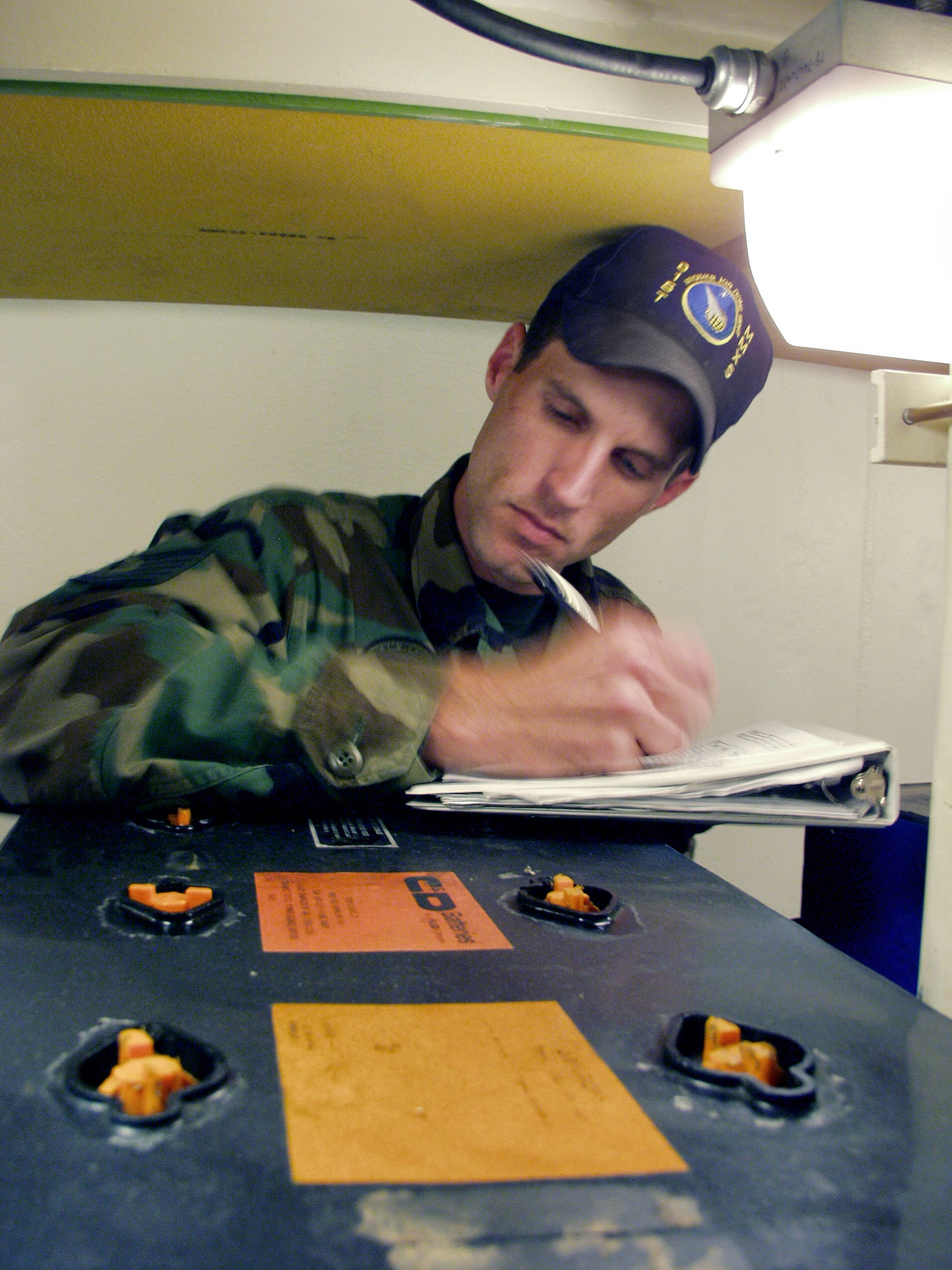 Tech. Sgt. Adam Chandler takes inventory of 32-volt batteries that ring a Minuteman III intercontinental ballistic missile launch tube during the annual code change Aug. 25. The NCO is a Minuteman III missile handling team chief with the 91st Missile Wing at Minot Air Force Base, N.D. (U.S. Air Force photo/Airman 1st Class Chris Boitz) 
