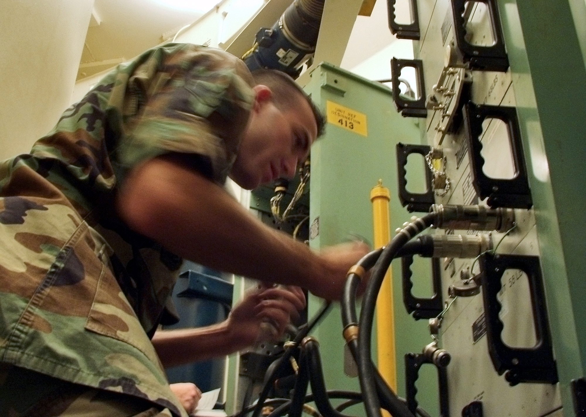 Airman 1st Class Matthew Lahood connects specialized equipment to the missile interface panel during the annual code change Aug. 25. The Airman is a Minuteman III missile handling team member with the 91st Missile Maintenance Squadron at Minot Air Force Base, N.D. (U.S. Air Force photo/Airman 1st Class Chris Boitz) 
