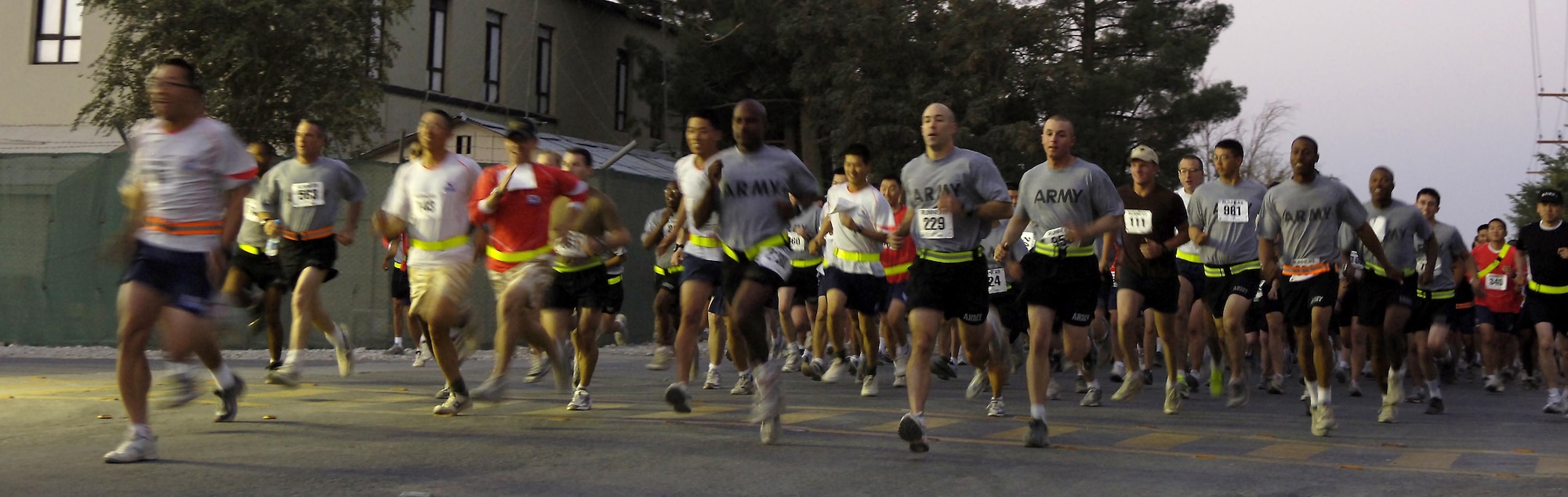 Runners sprint to the front of the pack to begin the Women's Equality Day 5K run at Bagram Air Base, Afghanistan, Aug. 28. More than 900 servicemembers participated in the event. (U.S. Air Force photo/Senior Airman Brian Ferguson)