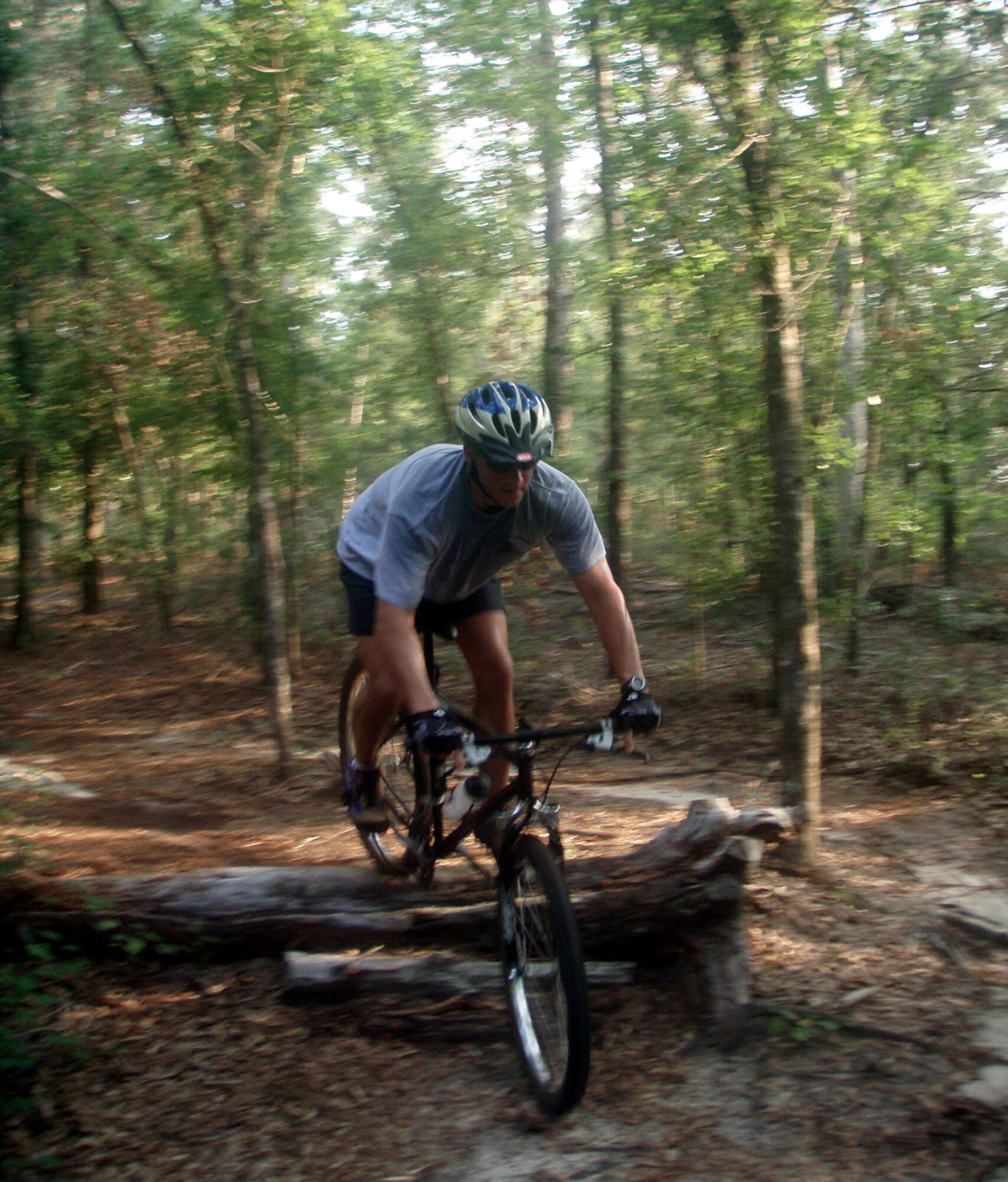 Maj. Steve Edwards, 14th Weapons School, hurdles a log during mountain bike practice for the 2006 Challenge World competition.  (Air Force Photograph by Maj. Bob Carlson)