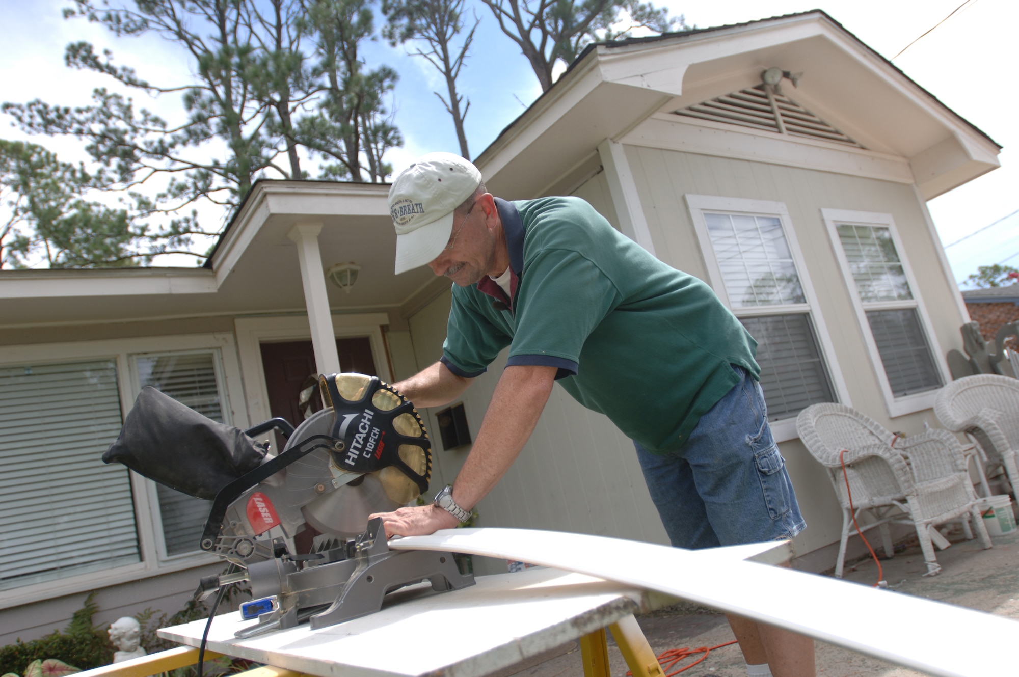 Master Sgt. Daniel Peters prepares a crown moulding for his house in Biloxi.  MSgt Peters is one of several Air Force members whose house was severely water damaged from Hurricane Katrina.  MSgt Peters of the 403rd Airlift Squadron on Keesler AFB, MS has been coming home everyday for the last year to repair his house.  (US Air Force photo/Tech Sgt. Cecilio Ricardo Jr.)