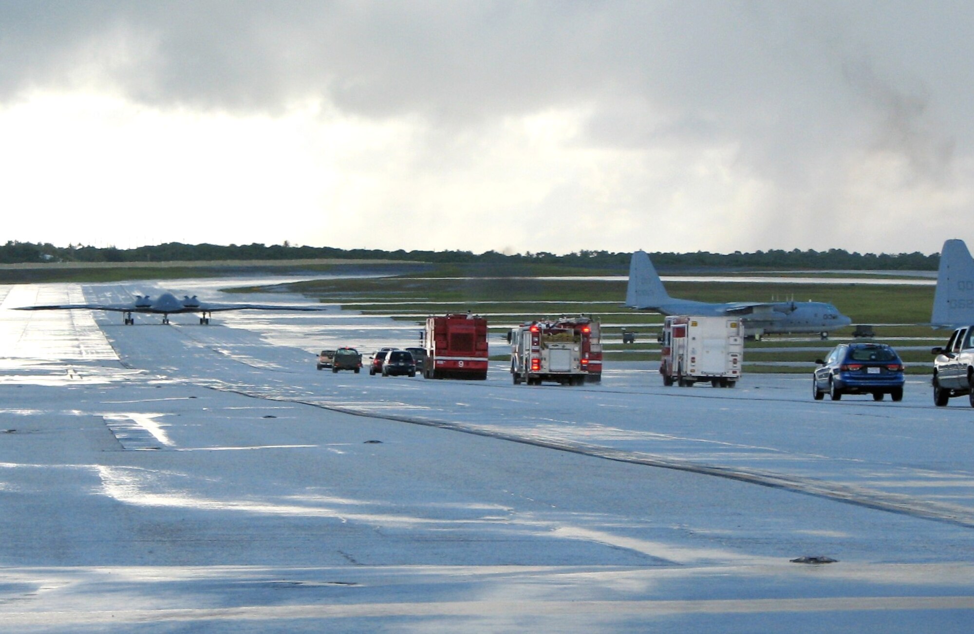 A line of vehicles follows a B-2 Spirit as it taxis on the flightline at Andersen Air Force Base, Guam, before departing on a training mission Aug. 24. The "elephant walk" highlighted one of the final sorties of the four-month deployment to the base from units at Whiteman AFB, Mo. (U.S. Air Force photo/Tech. Sgt. Mikal Canfield) 