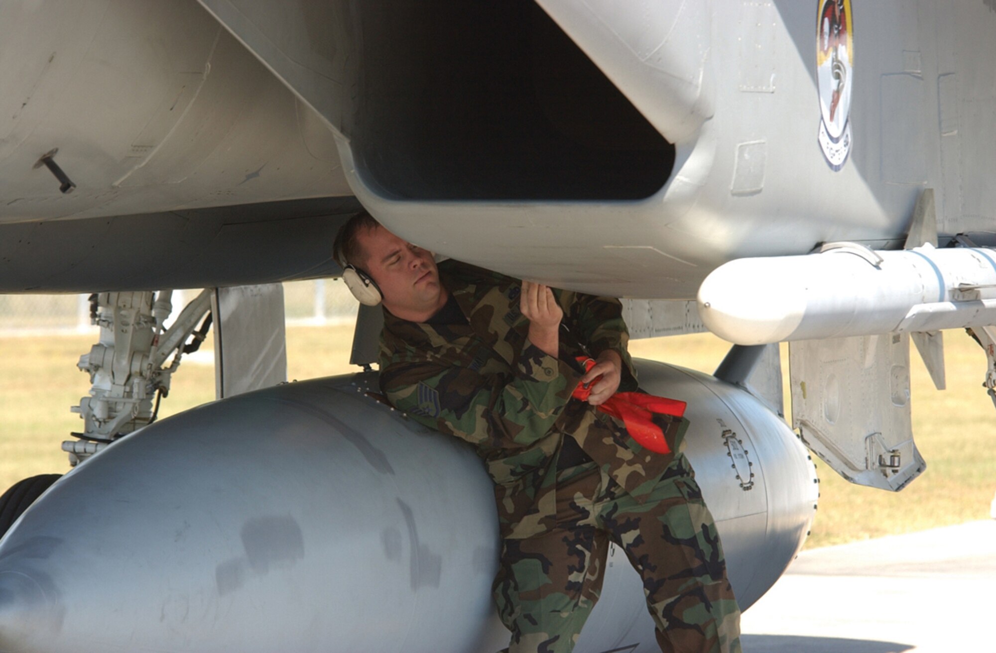 Staff Sgt. Rich Murray, 1st Aircraft Maintenance Unit crew chief, finishes pulling all the safety pins from an F-15 Eagle during an alert scramble. (U.S. Air Force photo by 2nd Lt. William Powell)