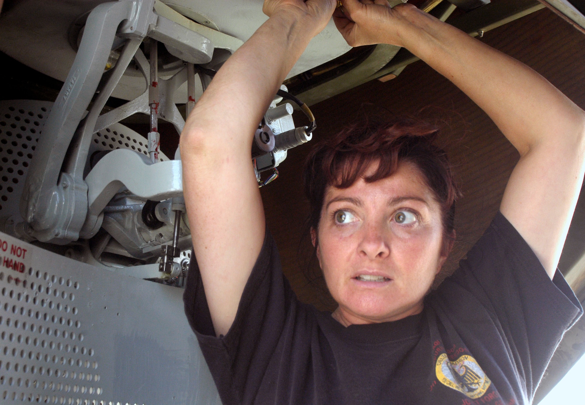 Master Sgt. Lorraine Guthrie installs safety wire on an APN-59 radar transmitter and receiver-set in the nose of a C-130 Hercules Aug 28 at Bagram Airfield, Afghanistan.  Sergeant Guthrie is a communication and navigation system technician from the 176th Maintenance Squadron, Alaska Air National Guard.  She is deployed to the 455th Expeditionary Maintenance Group at Bagram in support of Operation Enduring Freedom.  The radar antenna needed to be replaced and the safety wire prevents the fasteners from vibrating loose during flight.  (US Air Force photo/Maj. David Kurle)                                